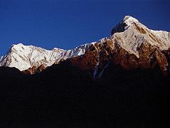 09 Nanga Parbat Rupal And East Faces, Rakhiot Peak From Tarashing At Sunrise The yellow light of sunrise quickly changes to white on the Nanga Parbat Rupal and East Faces from Tarashing. Rakhiot Peak is on the right. Gunther Messners diary May 15, 1970: The day dawns bright and cloudless. For the first time I see Nanga and Chongra Peak from the south: the impression is overwhelming. Huge hanging glaciers, terrifying precipices, furrowed by avalanches. Right over to the left is the summit of Nanga! (The Naked Mountain by Reinhold Messner)